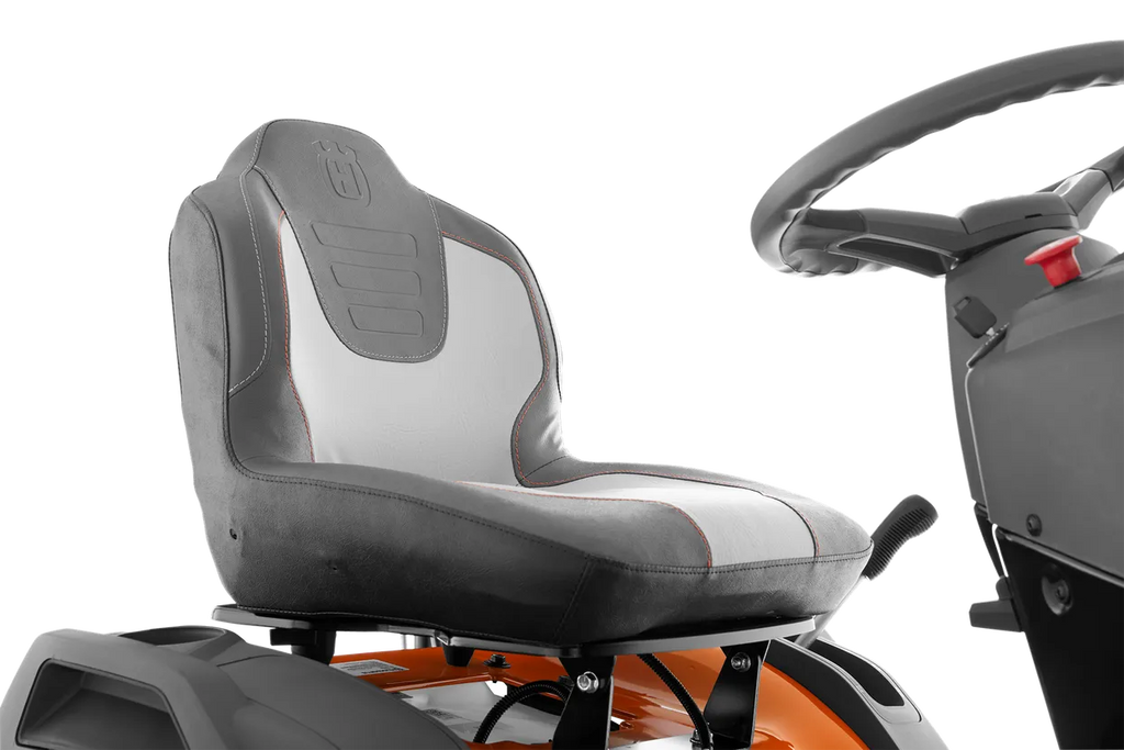 Gray seat and steering wheel of a lawn mower on a white background