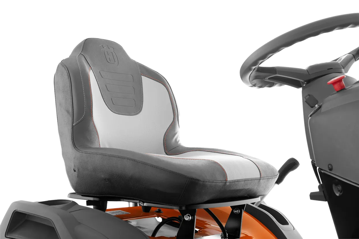 Gray seat and steering wheel of a lawn mower on a white background