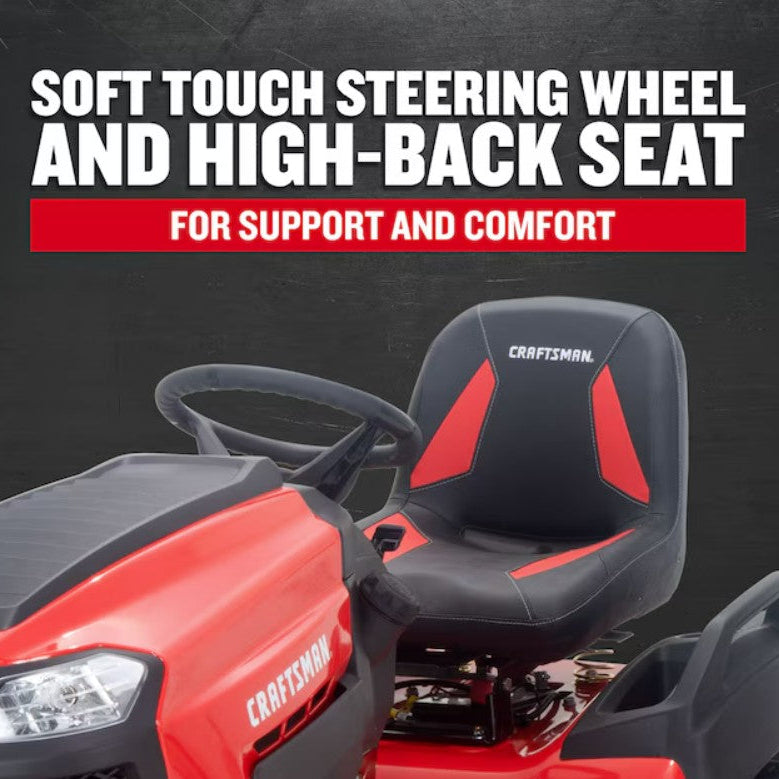 Red and black riding lawn mower with steering wheel and seat on a dark background