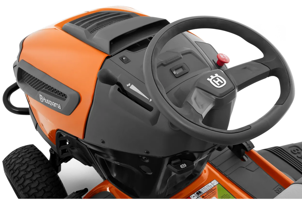 Close-up of a Husqvarna lawn mower with steering wheel on a white background
