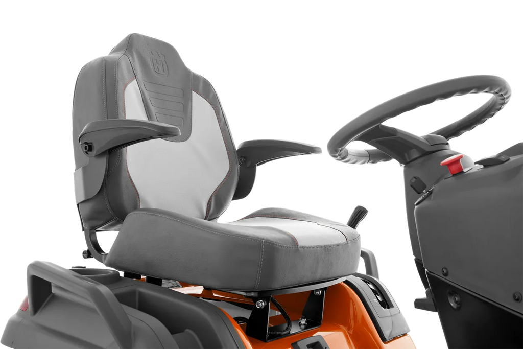 Gray seat and steering wheel of a piece of machinery on a white background